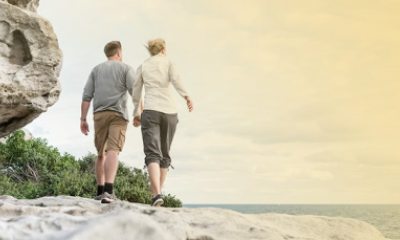 An older couple walking on the beach