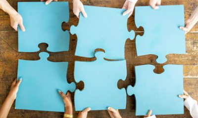Close-up of hands configuring giant puzzle pieces properly