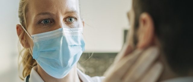 A health care provider examines a patient