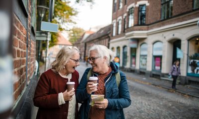 Two people joyfully talk while walking outside 