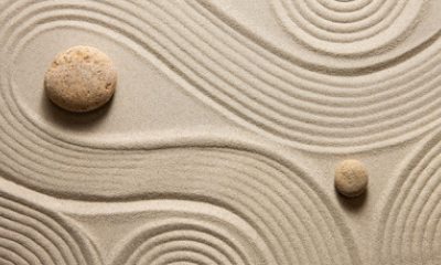 Swirls of sand around rocks in a zen garden