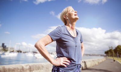 Woman standing outside rests during exercise
