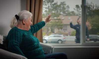 Maggie Donathan waves through her window to Wendy Sullivan