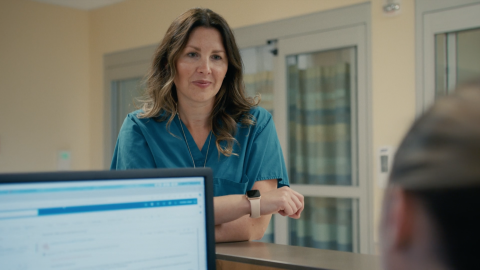 Sarah Cook checks in with staff at nurse's desk/station